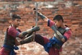 Fighters take part in an outdoor ancient Thai fencing.