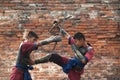 Fighters take part in an outdoor ancient Thai fencing.