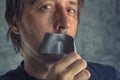 Fighting censorship, man removing duct tape from mouth Royalty Free Stock Photo