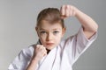 Fighting position for self-defense of a little girl in karate. Close-up, portrait