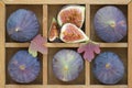 Figs and autumn leaves in a wooden box