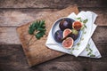 Figs in flat dish on choppingboard and napkin in rustic style Royalty Free Stock Photo