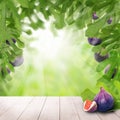 Figs fruit, green leaves and white empty wooden table