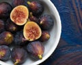 Figs fruits in a bowl on dark background, top view. Royalty Free Stock Photo