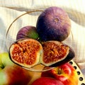 Figs in a glass vase. Three purple fruits. Figs cut in two. Royalty Free Stock Photo