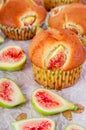 Figs muffins with fresh fruits on baking paper and wooden background Royalty Free Stock Photo