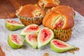 Figs muffins with fresh fruits on baking paper and wooden background Royalty Free Stock Photo