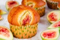 Figs muffins with fresh fruits on baking paper and wooden background Royalty Free Stock Photo