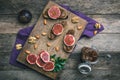 Figs, nuts and bread with jam on choppingboard in rustic style Royalty Free Stock Photo