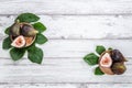 Figs on wooden plates and fig leaves. White wood background. Top view Royalty Free Stock Photo