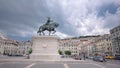 Figueira Square in the Baixa district. King Dom Joao I statue and Sao Jorge Castle on top of hill timelapse Royalty Free Stock Photo