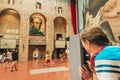 Figueres, Spain- August 19, 2019: Young girl tourist admiring `Lincoln in Dalivision` in Dali Museum