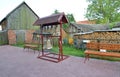 Figurative folding belfry with church bells in a yard of the rural house, Russia Royalty Free Stock Photo