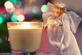 Christmas angel looking at the candle flame, new year background Royalty Free Stock Photo