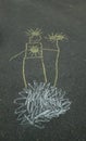 Chalk drawing on the asphalt. The cloud is a huge figure of Lord sun. Symbol of solar energy. Royalty Free Stock Photo