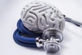 The figure on the brain is on twisted into a spiral tube of the stethoscope with chestpiece, which as it listens to the human brai