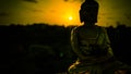 Figure of Buddha with the setting sun Royalty Free Stock Photo
