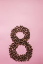 Figure 8 from coffee beans on a lilac background Royalty Free Stock Photo