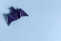 The figure of a dark bat on a colored background. The concept of a Halloween invitation Royalty Free Stock Photo