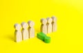 The figure of a green man falls out of a number of people on a yellow background. The concept of a toxic employee in the team