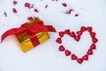The figure of a heart laid out on the snow of little red hearts on the snow on Valentine`s Day .a surprise gift around. backgroun Royalty Free Stock Photo
