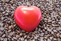 Figure heart is among roasted coffee beans. Effects of coffee and caffeine on heart function, heartbeat, rhythm, and role in devel