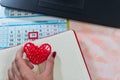 Figure heart in a woman`s hand at the Desk