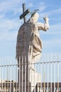 Figure of Jesus on the top of the facade of Saint Peter`s Basilica on a blue sky background, Vatican, Rome, Italy Royalty Free Stock Photo