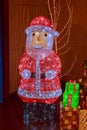 Figure of a large Russian New Year`s Santa Claus decorated with multicolored sparkling garlands