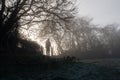 A figure looking into the mist. On a frosty, atmospheric winters day in the countryside