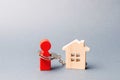 The figure of a man is handcuffed to a wooden house. Impossibility of paying interest rates on mortgages and repayment of loans. Royalty Free Stock Photo