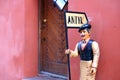 Figure of a man holding a sign `antyk` `antiques` at the entrance to a shop selling antiques Royalty Free Stock Photo