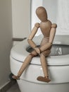 Figure of a man sitting on the toilet, constipation, bowel disease, prevention and treatment