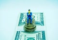 Man in a suit on top of a pile of coins in a white background Royalty Free Stock Photo