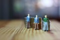 figure business men minimal toys standing in front of coins stack,money concept