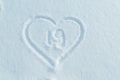 A figure of Nineteen written in the snow in the painted heart.