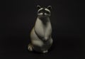 Figure of a raccoon on a dark background