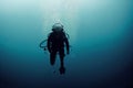 The figure of a scuba diver and a diver underwater view of the deep ocean in blue tones. Royalty Free Stock Photo