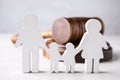 Figure in shape of people and wooden gavel on table. Family law concept