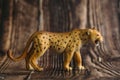 Figure of a toy Cheetah on a wooden background