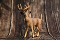 Figure of a toy deer on a wooden background