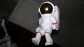 Figure of white astronaut, spaceman suspend in air. Indoor. Doll