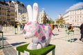 The figure of a white Easter Bunny with painted Easter eggs on it in pink and purple color. Beautiful Easter decoration art. Kyiv