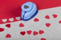 Figured plastic paper punch and handmade red hearts.