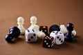 The figures of the board game dice chess backgammon close up on a brown background with a copy space. Play board games
