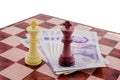 Figures Of Chess On Chessboard And English Money Pounds