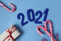Figures of the coming New year - 2021 - cut out of paper , with a festive caramel and a gift, top view, close - up-the concept of Royalty Free Stock Photo