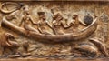 Ancient Egyptian relief depicting figures in a ceremonial boat, surrounded by hieroglyphs, showcasing a traditional Royalty Free Stock Photo