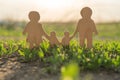 Figures of a family with children outdoors nature. games on the grass