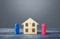 Figures of husband and wife and house puzzle. Marriage contract. Buying or building a dream home. Division of marital property Royalty Free Stock Photo